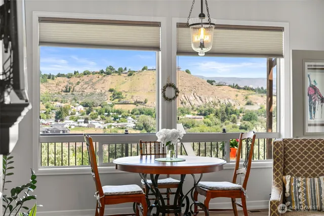 a dining room with furniture a chandelier and wooden floor