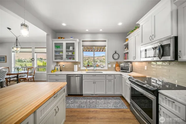 a kitchen with stainless steel appliances granite countertop a stove and a sink