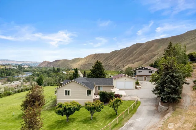 a view of a house with a mountain in the background