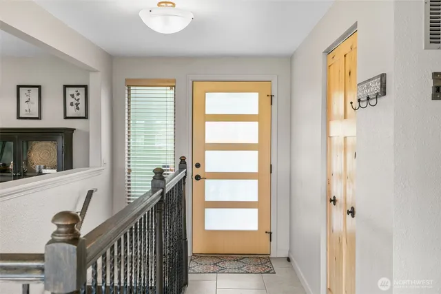 a view of an entryway with wooden floor and windows