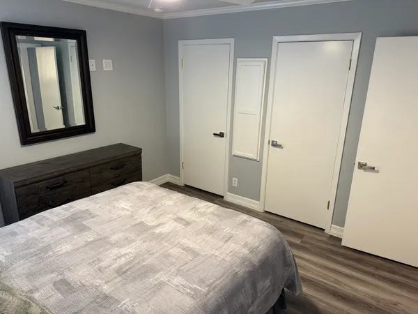 a bedroom with a bed and a mirror