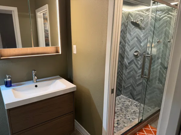 a bathroom with a sink and a mirror