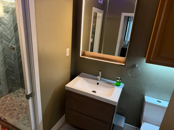 a bathroom with a sink and a mirror
