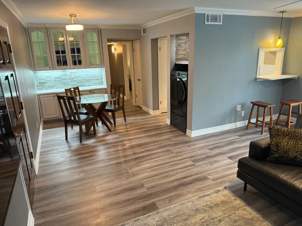 a view of a dining room with furniture and wooden floor