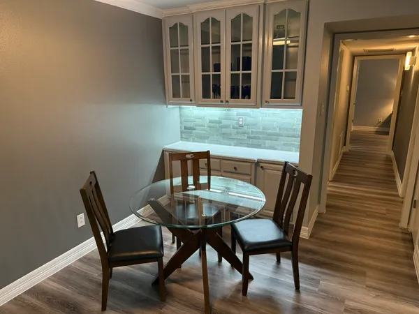 a view of a dining room with furniture and wooden floor