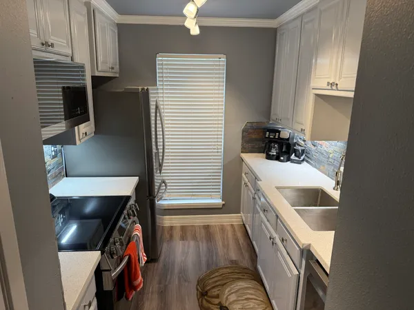 a kitchen with a sink and a refrigerator