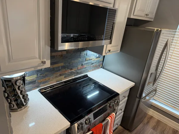 a kitchen with a stove and a microwave