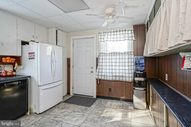 a kitchen with a refrigerator and a sink