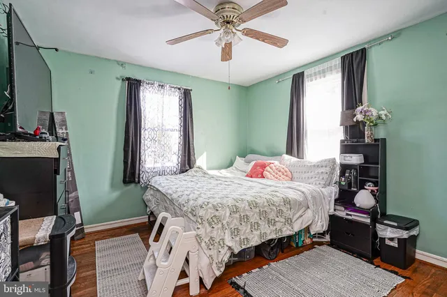 a bedroom with a bed dresser and a window