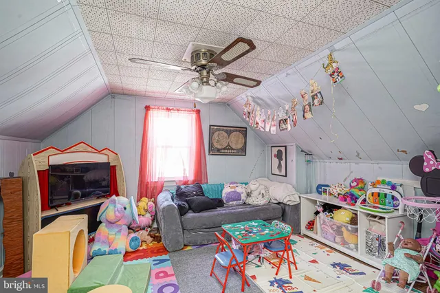 a living room filled with furniture and a baby crib