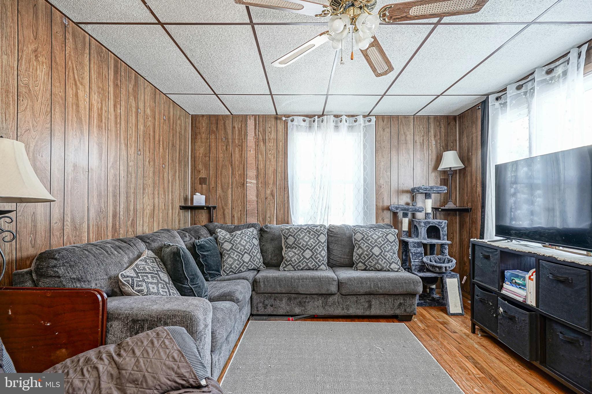 1345 East Walnut Road Vineland, NJ 08361 - Photo 5 of 26 a living room with furniture a flat screen tv and a chandelier