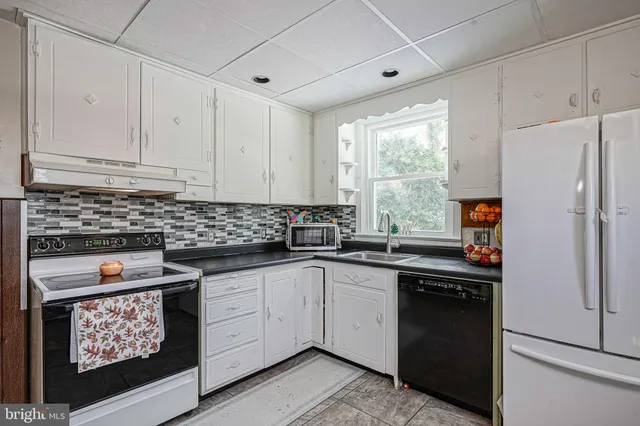 a kitchen with stainless steel appliances granite countertop a refrigerator sink and cabinets