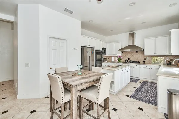 a kitchen with stainless steel appliances kitchen island granite countertop a sink and cabinets