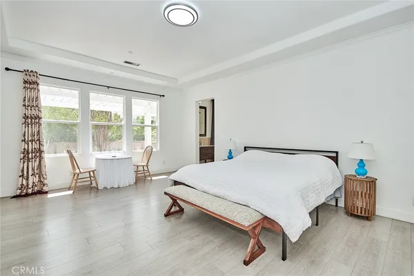 a bed room with a bed and a chair