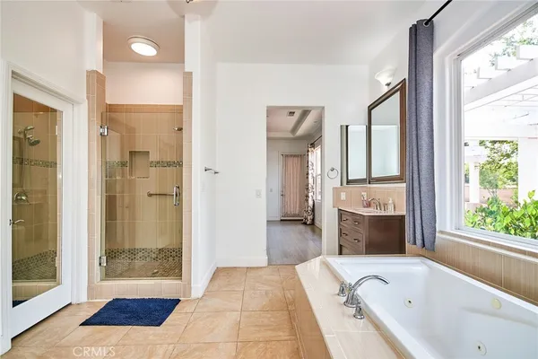 a bathroom with a tub shower and sink