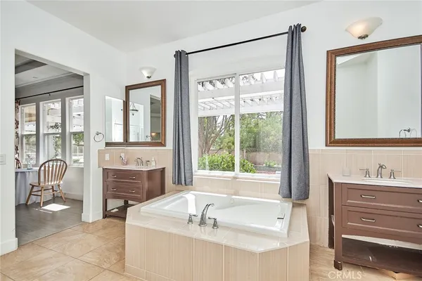 a spacious bathroom with sink shower and bathtub
