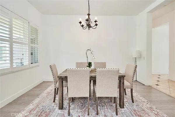 a view of a dining room with furniture and chandelier