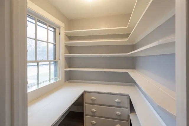 a view of walk in closet with empty racks