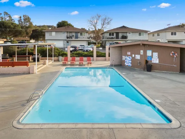 an outdoor space with swimming pool and furniture