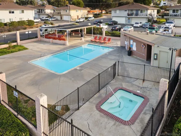 a view of a patio with table and chairs potted plants with floor to ceiling window