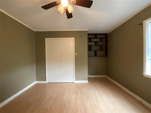 an empty room with a empty space and a ceiling fan