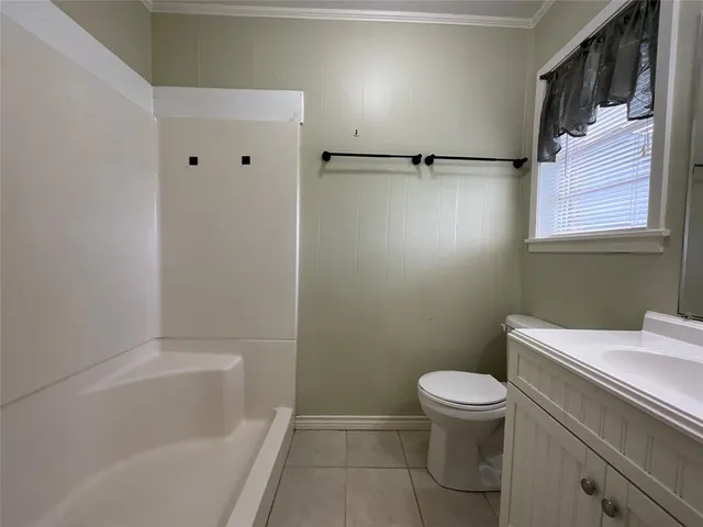 a bathroom with a toilet a sink and bathtub