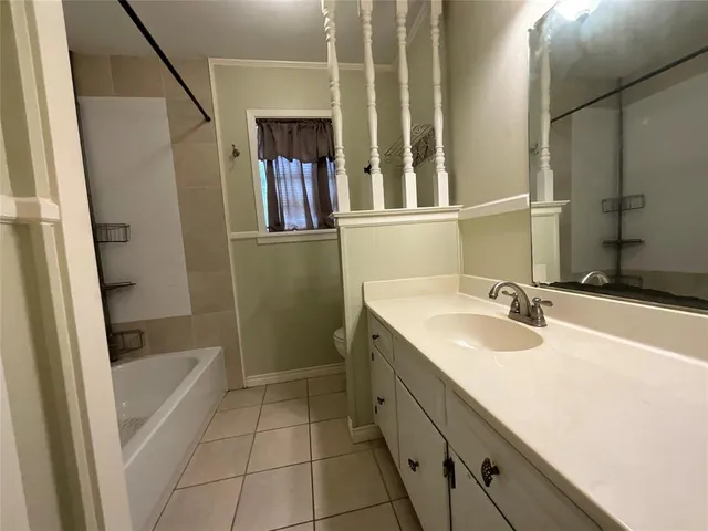 a bathroom with a tub sink and mirror