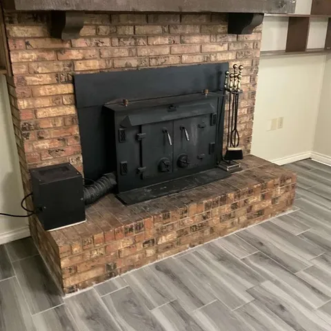 a view of fireplace and wooden floor