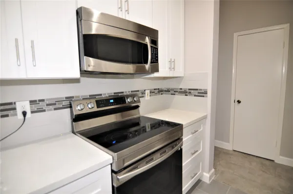 a kitchen with a stove and a microwave