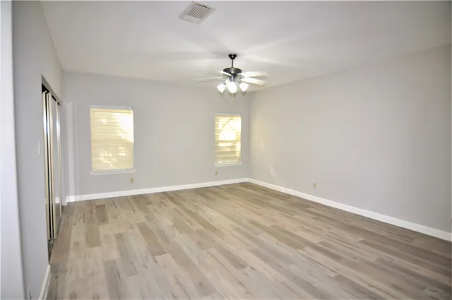 wooden floor in an empty room with a window