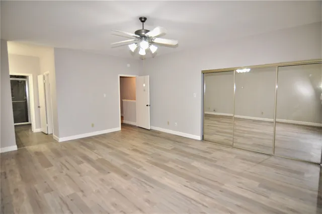 a view of an empty room with wooden floor