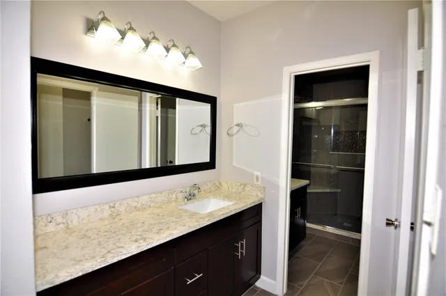 a bathroom with a sink vanity and a mirror
