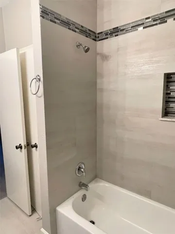 a bathroom with a shower and a bath tub
