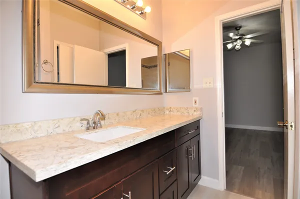 a bathroom with a sink vanity and mirror