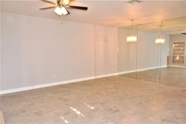 an empty room with fan and fan