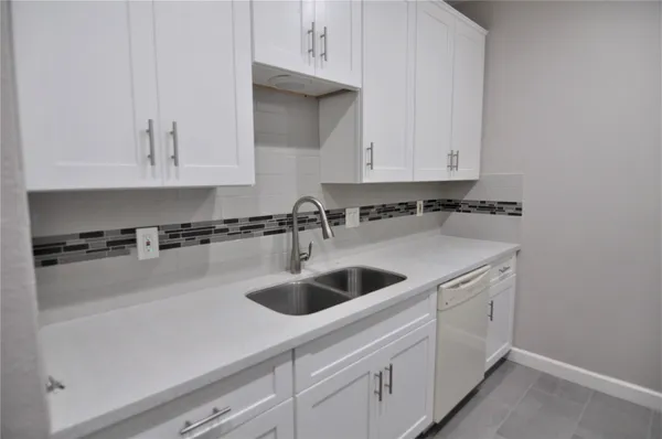 a kitchen with a sink and cabinets