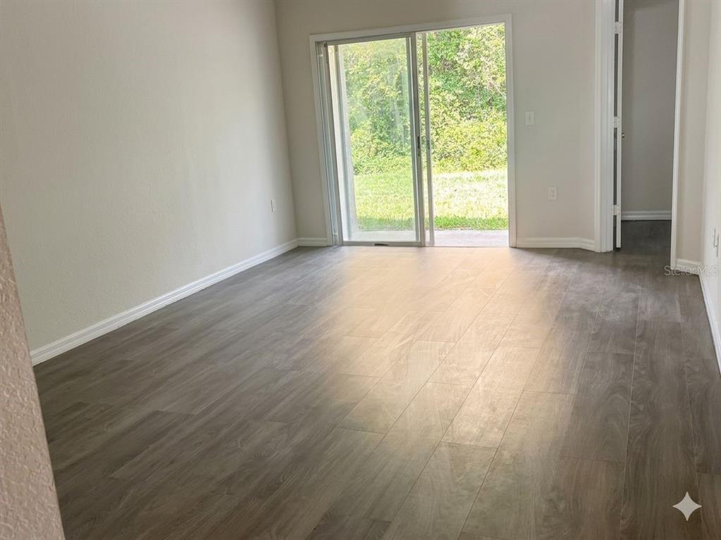 16262 Southwest 29th Court Road Ocala, FL 34473 - Photo 4 of 5 a view of an empty room with wooden floor and a window