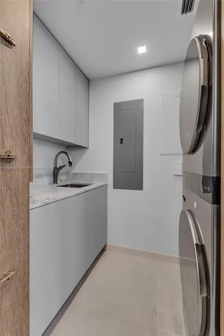 a large white kitchen with a large window