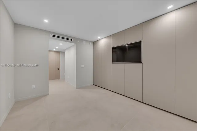 a view of an empty room with a tv