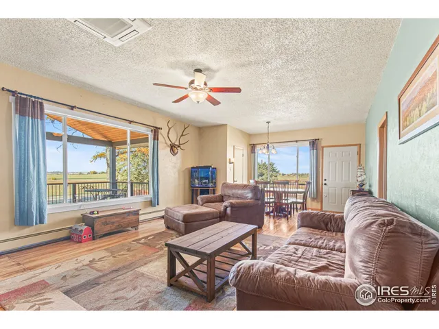 a dining room with furniture window and wooden floor