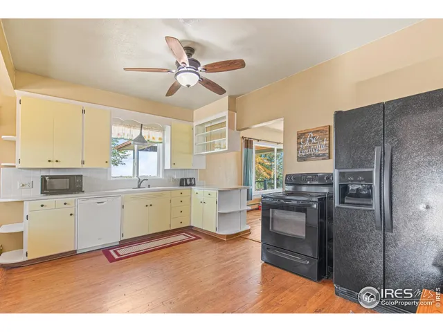 a view of kitchen with refrigerator microwave and cabinets