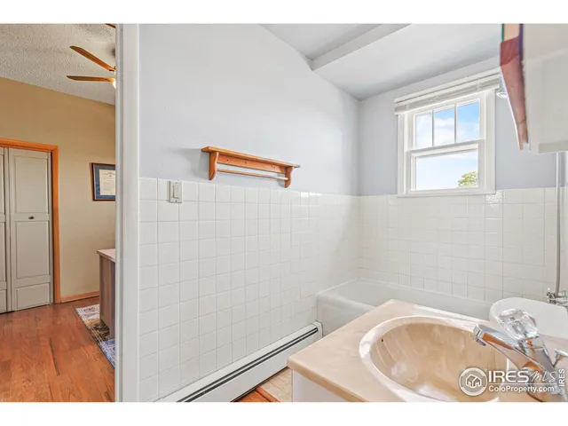 a bathroom with a sink toilet and a mirror