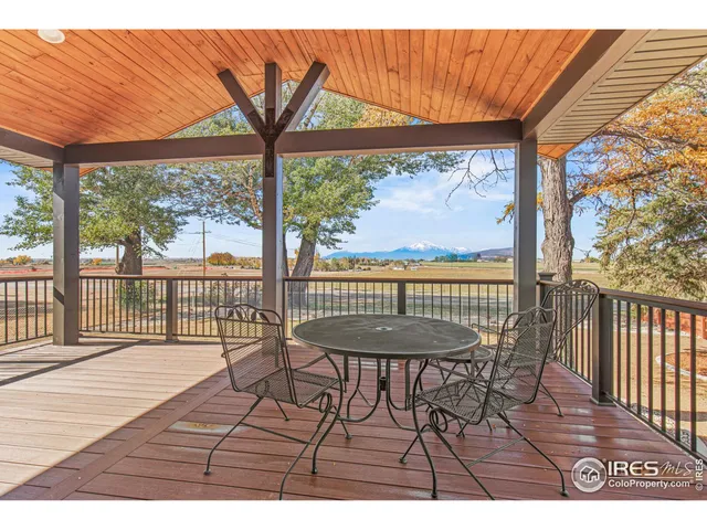 a view of a room with wooden floor and outdoor seating