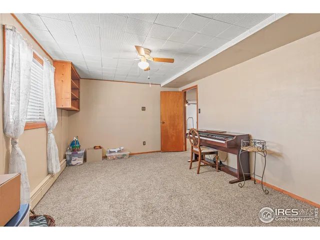 a room with gym equipment and wooden floor