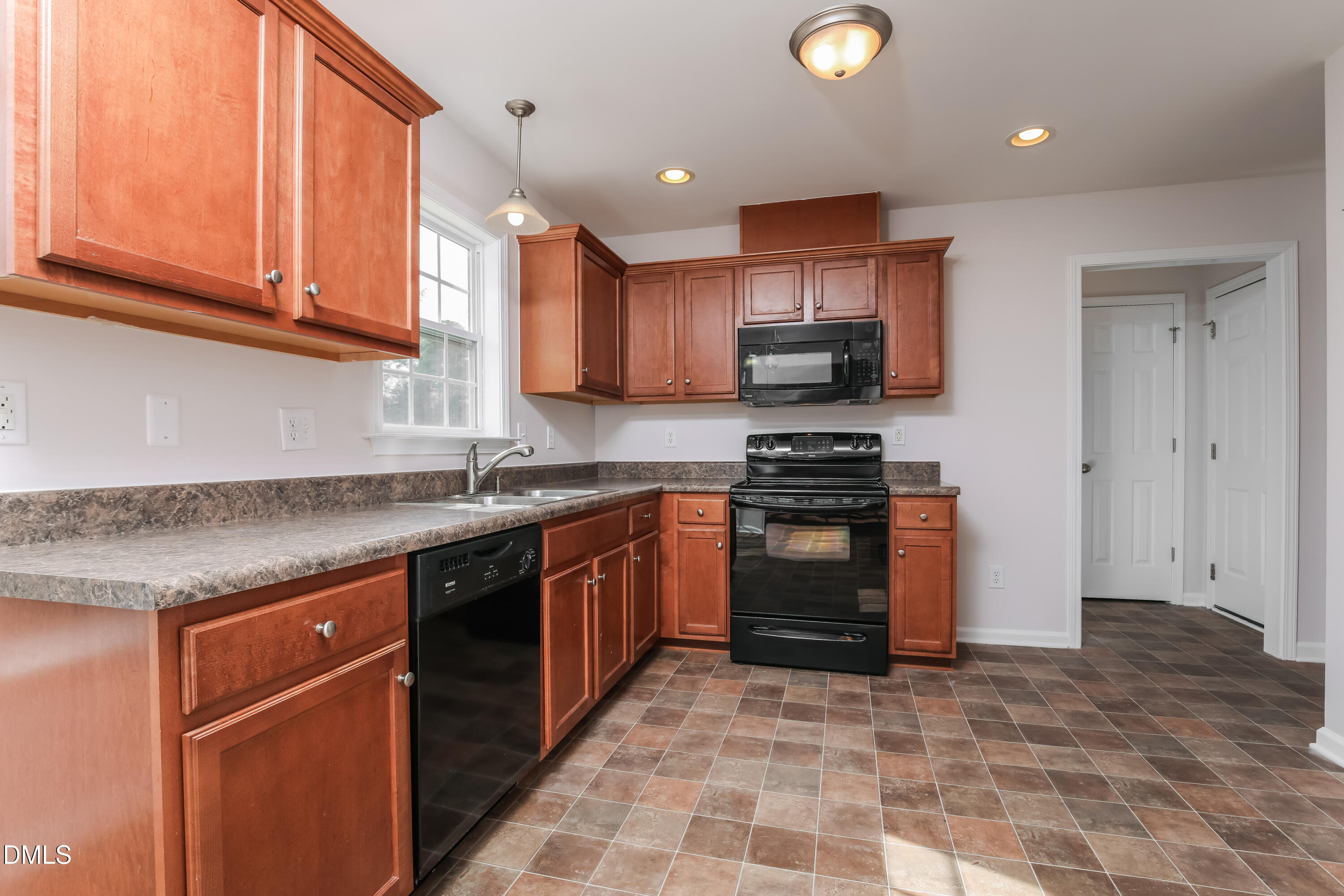 40 Broadhead Court Angier, NC 27501 - Photo 6 of 20 a kitchen with stainless steel appliances granite countertop a stove a sink and a refrigerator