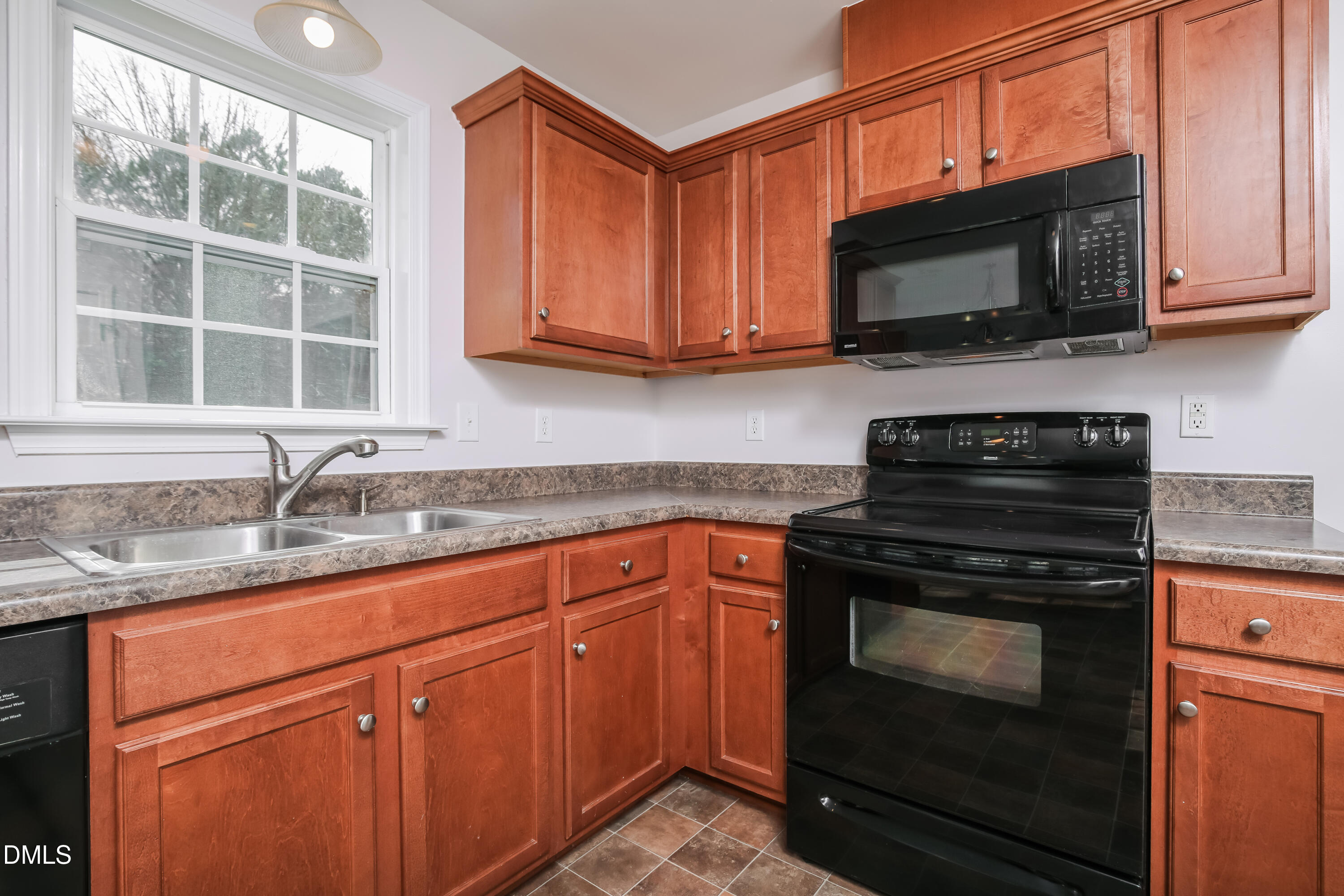 40 Broadhead Court Angier, NC 27501 - Photo 7 of 20 a kitchen with stainless steel appliances granite countertop a stove microwave and sink