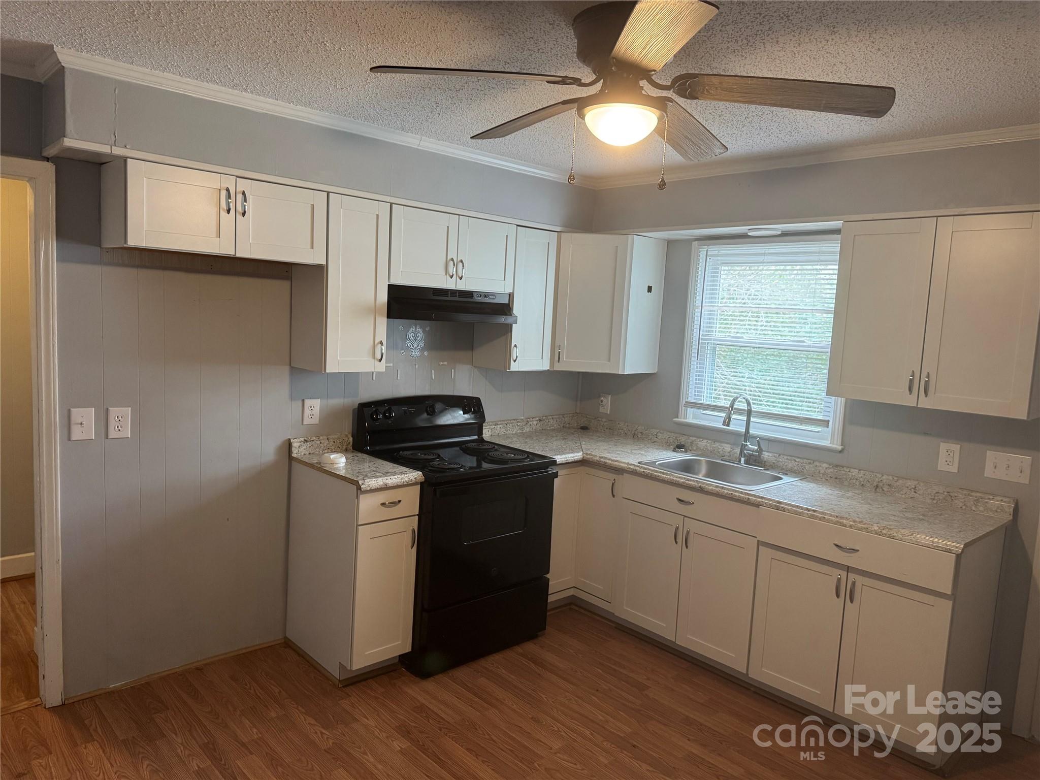 112 Chaney Street Wingate, NC 28174 - Photo 4 of 7 a kitchen with stainless steel appliances granite countertop a sink stove and refrigerator