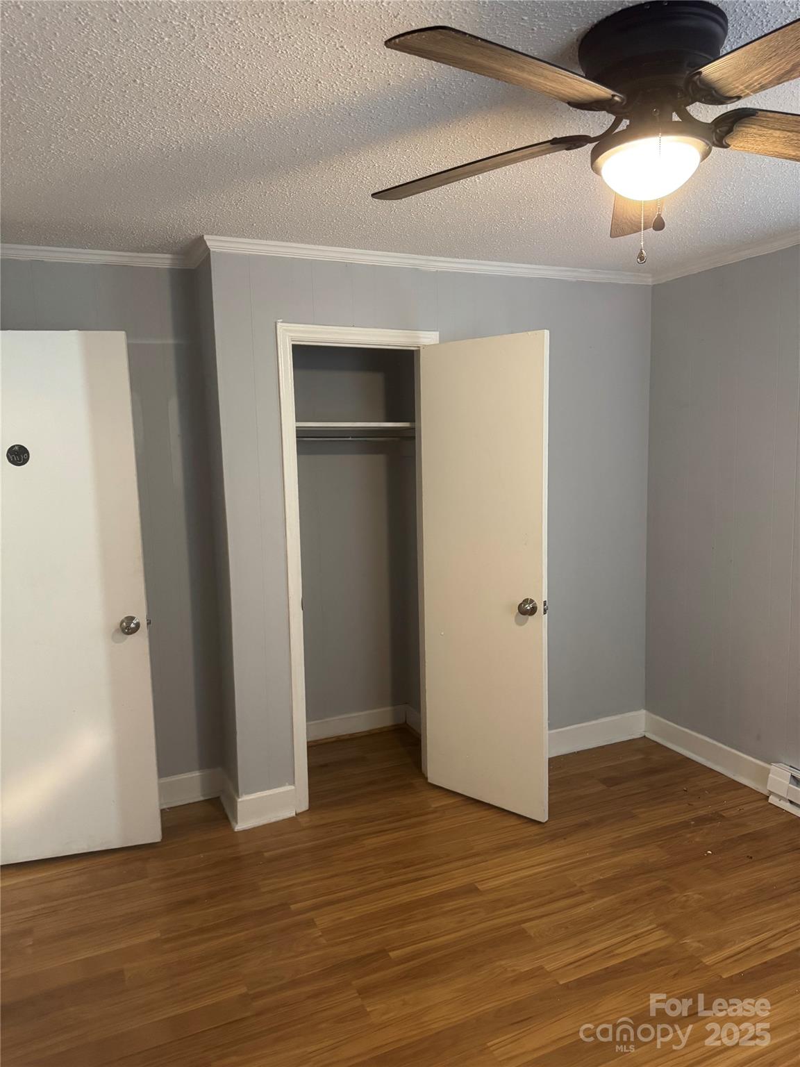 112 Chaney Street Wingate, NC 28174 - Photo 6 of 7 a view of an empty room with wooden floor