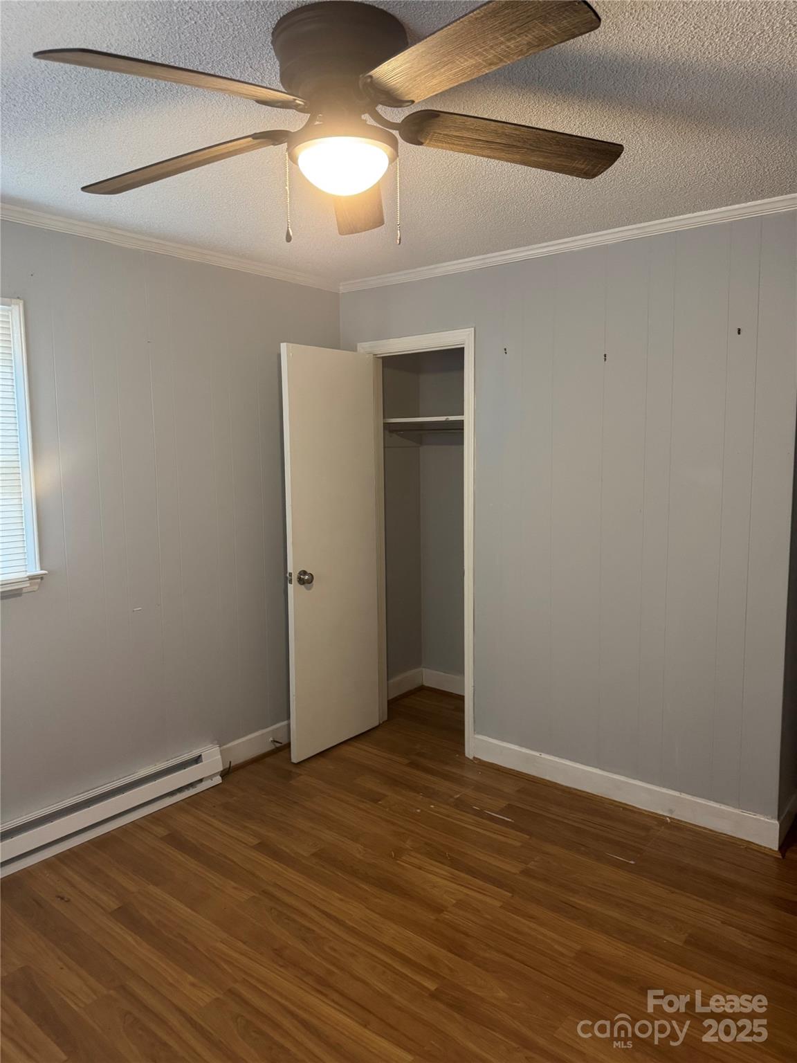 112 Chaney Street Wingate, NC 28174 - Photo 7 of 7 a view of an empty room with wooden floor
