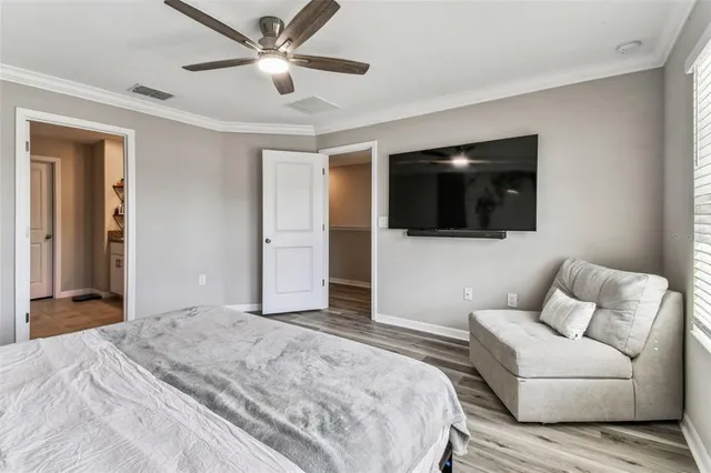 a bedroom with a bed a window and a television